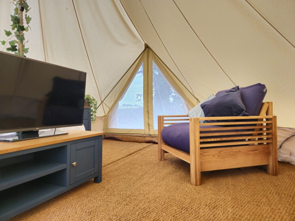 View of Futon and TV inside Bell Tent